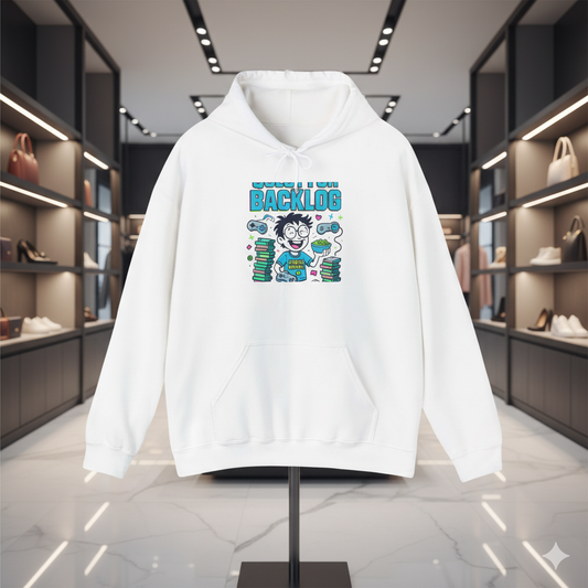 “White hoodie featuring a humorous ‘Stuck in Backlog’ gamer cartoon design, displayed on a stand inside a modern luxury fashion boutique with soft spotlights and premium store decor.”