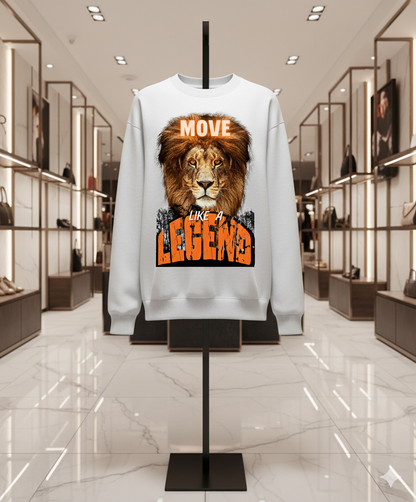 A unisex crewneck sweatshirt featuring a bold lion face with the text “MOVE LIKE A LEGEND” in modern typography.