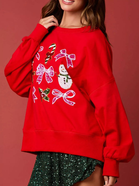 “Front view of women wearing a cozy Christmas sweatshirt with sparkling sequin bow, perfect festive holiday outfit for winter celebrations.”