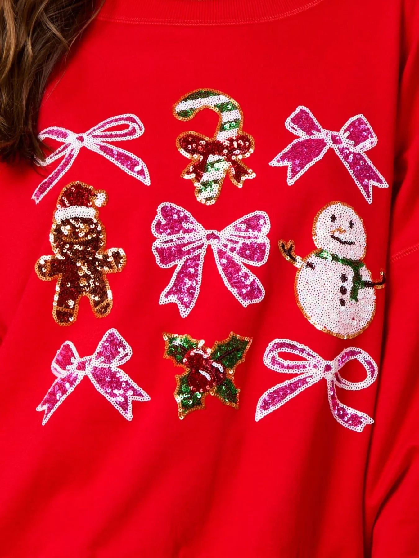 “Front view of women wearing a cozy Christmas sweatshirt with sparkling sequin bow, perfect festive holiday outfit for winter celebrations.”